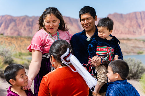 Happy Indigenous family in tradtional regalia outside