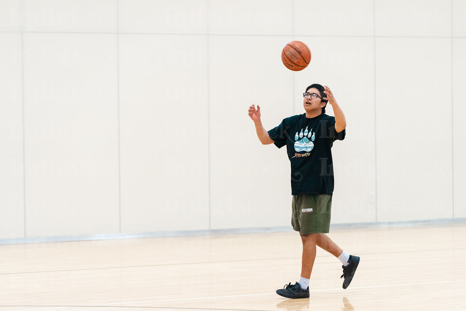 Native youth playing basketball