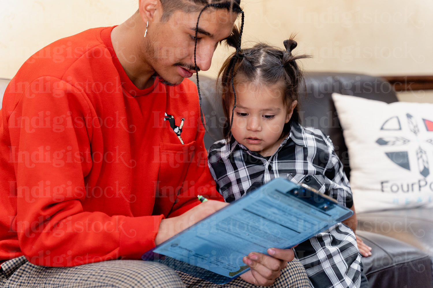 A Native father with his child waiting at a health clinic 