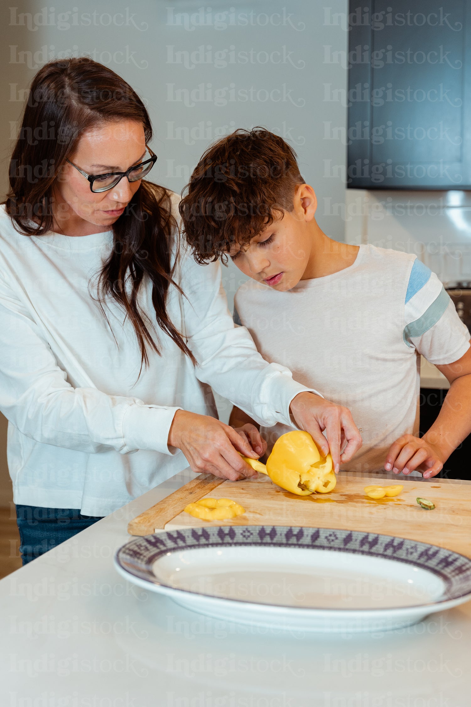 A mother teaching her child how to cook