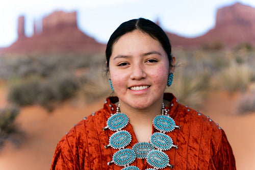 Young Native youth wearing traditional clothing and regalia outs