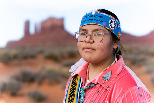 Young Native youth wearing traditional clothing and regalia outs