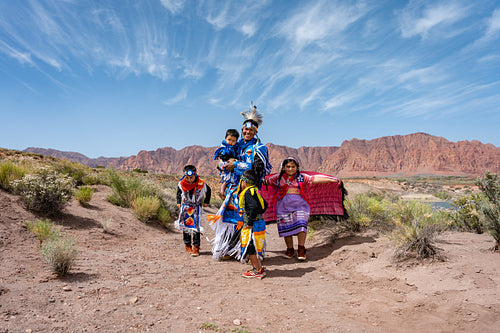 Happy Indigenous family in tradtional regalia outside