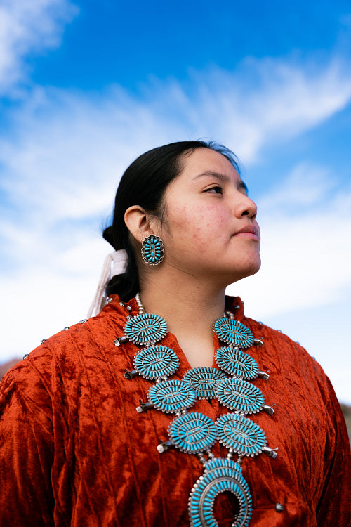 Young Native youth wearing traditional clothing and regalia outs