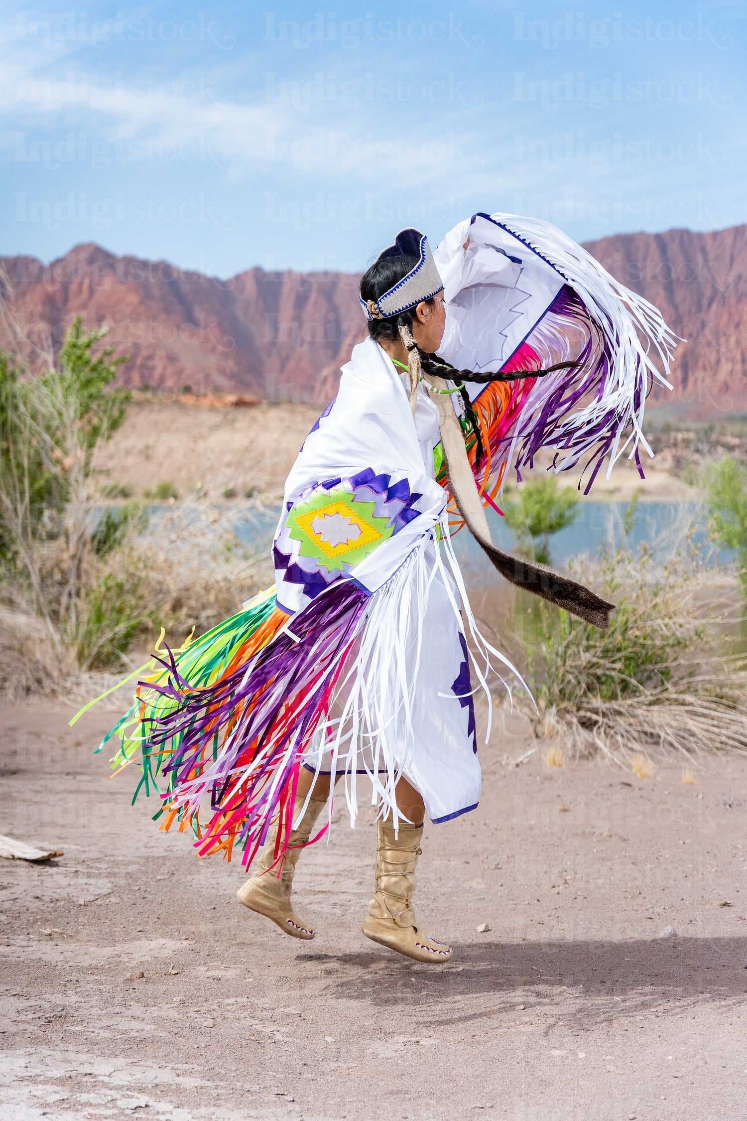 A young Native woman in traditional clothing and regalia 