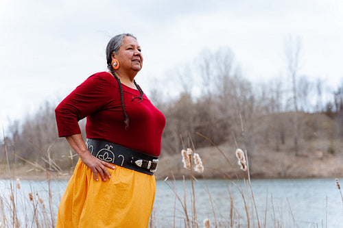 Indigenous elder woman on lake shore