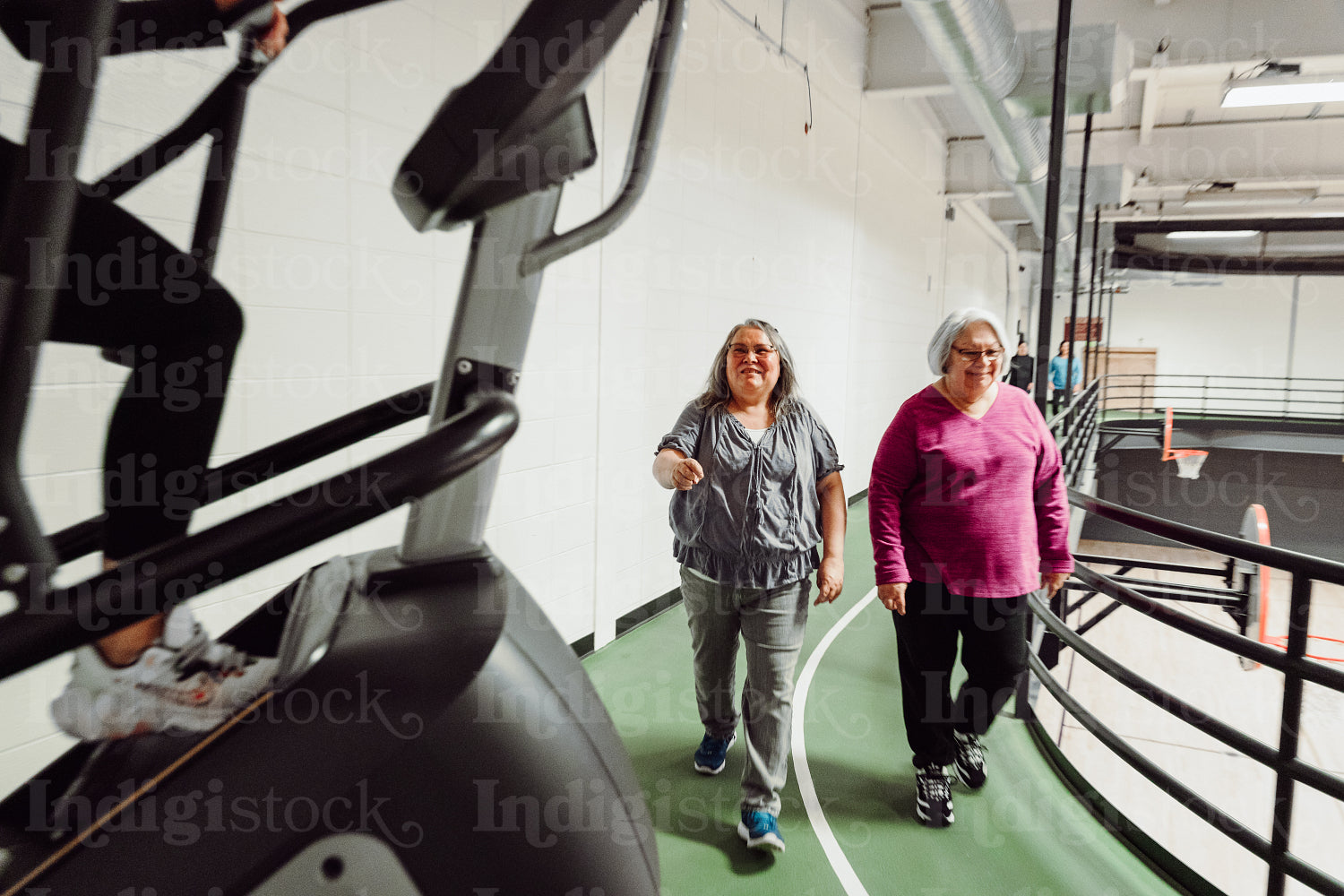 Indigenous women walking on a track