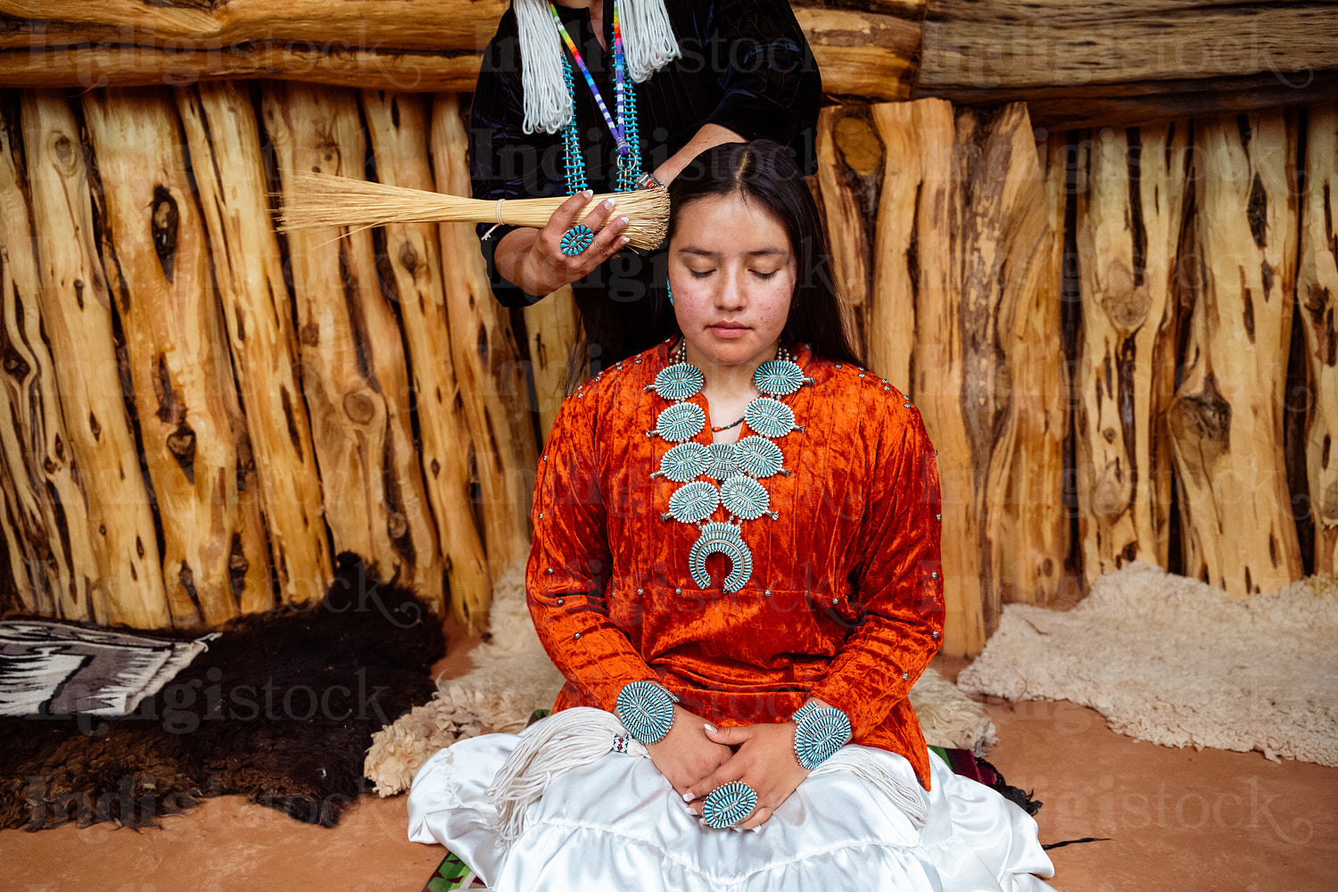 Native Women wearing traditional regalia in Earth Lodge