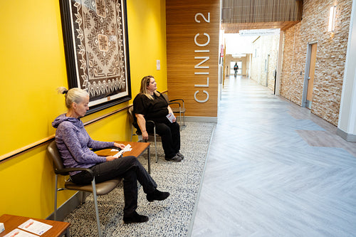 Two women waiting at a health clinic