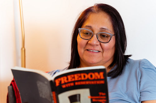 An elder reading a book