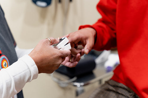 An Indigenous man being check by a native health care nurse