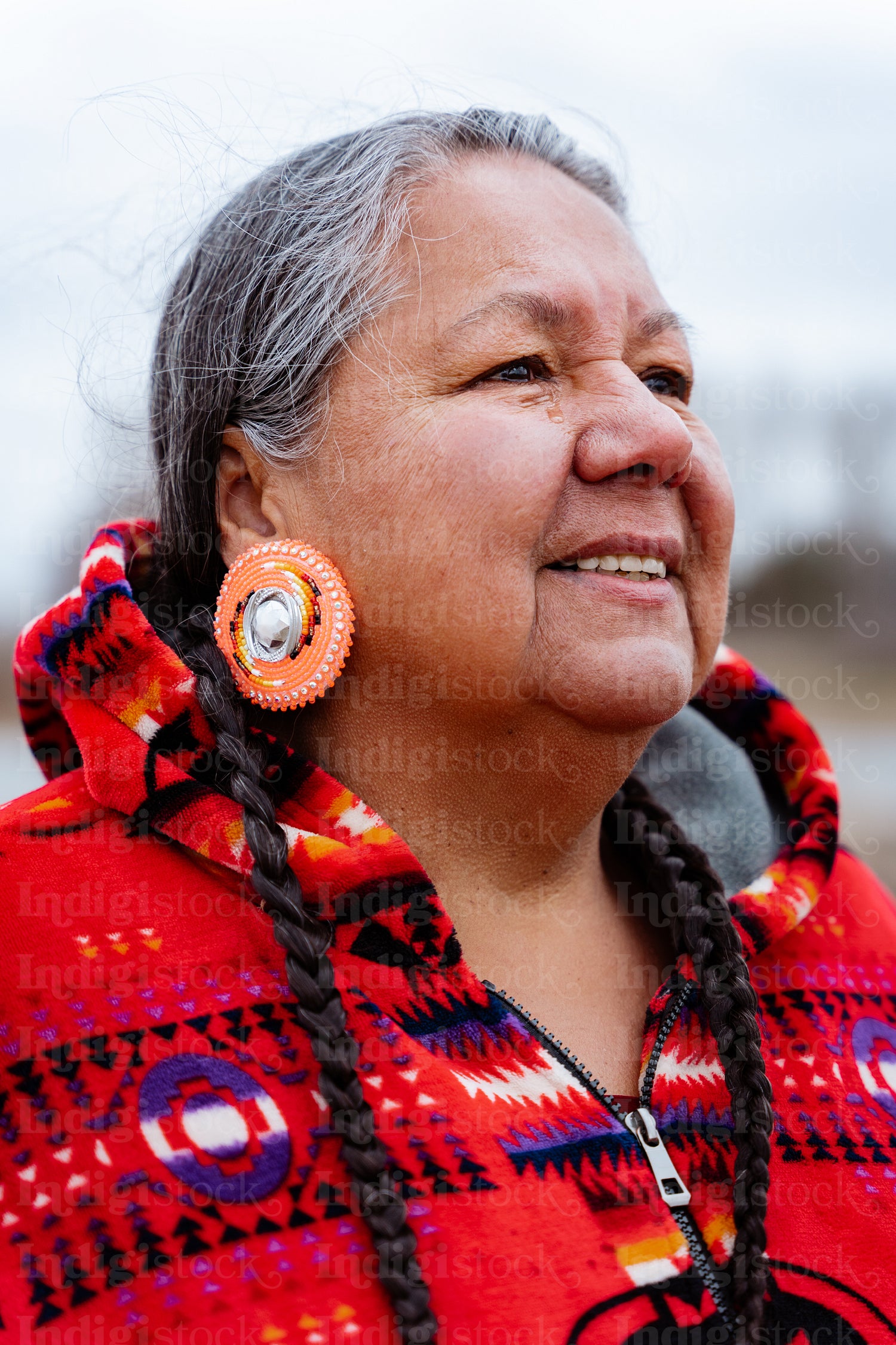 Indigenous elder woman on lake shore