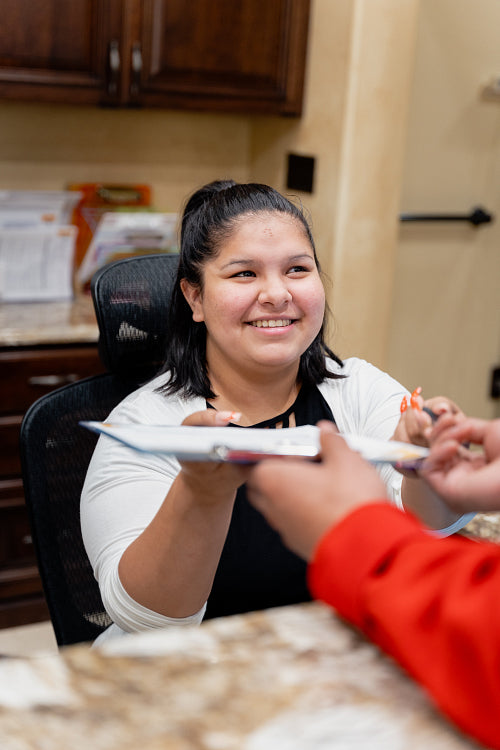 A young Native Man signing into a health clinic