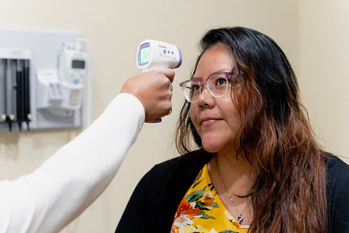 A native woman getting checked by an indigenous nurse