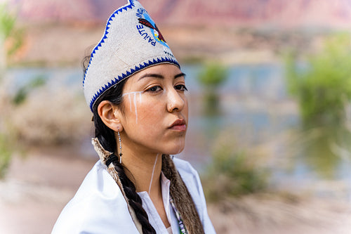 A young Native woman in traditional clothing and regalia