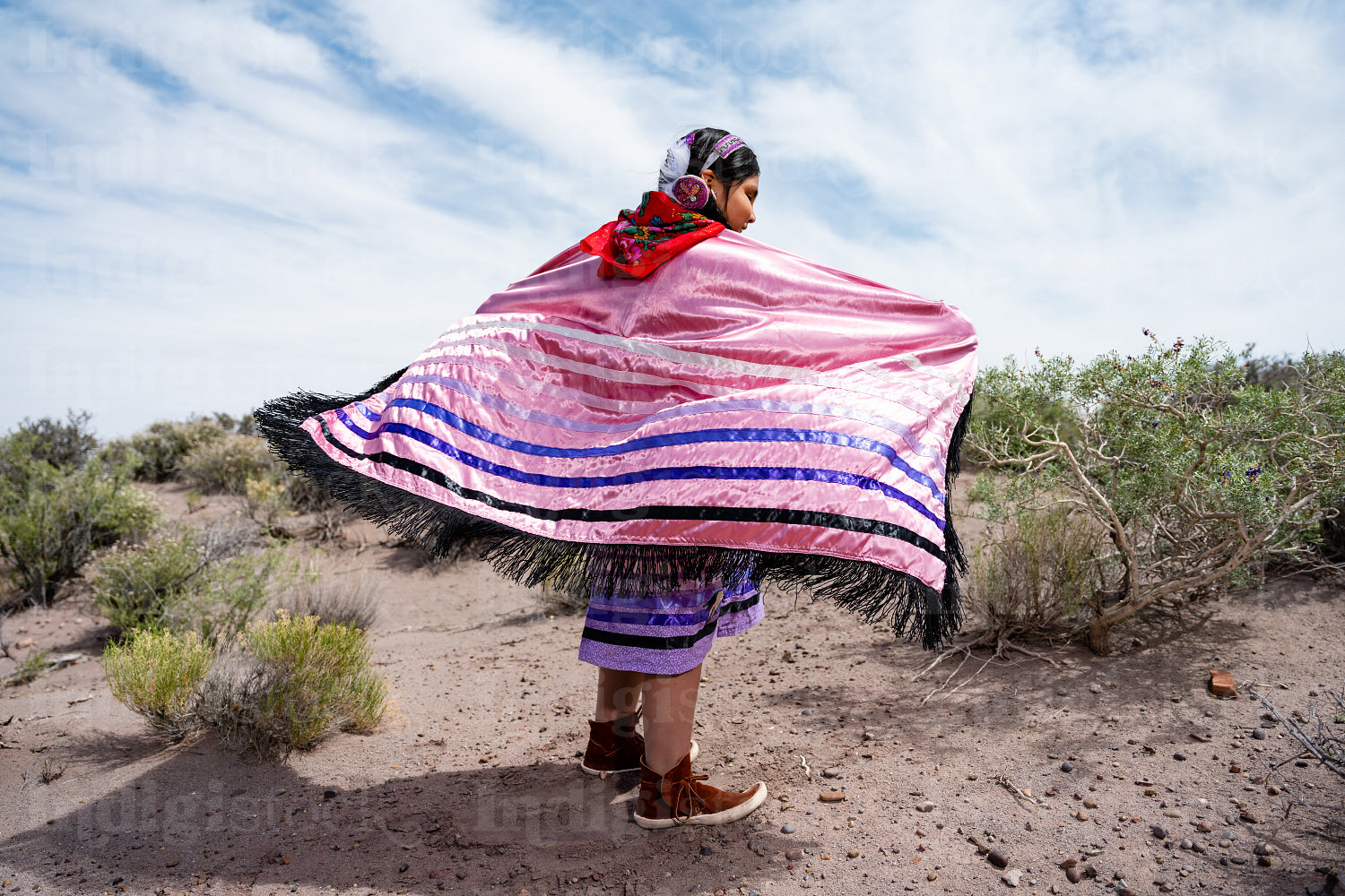 Young Native girl wearing traditional regalia outside