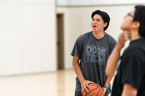 Native youth playing basketball