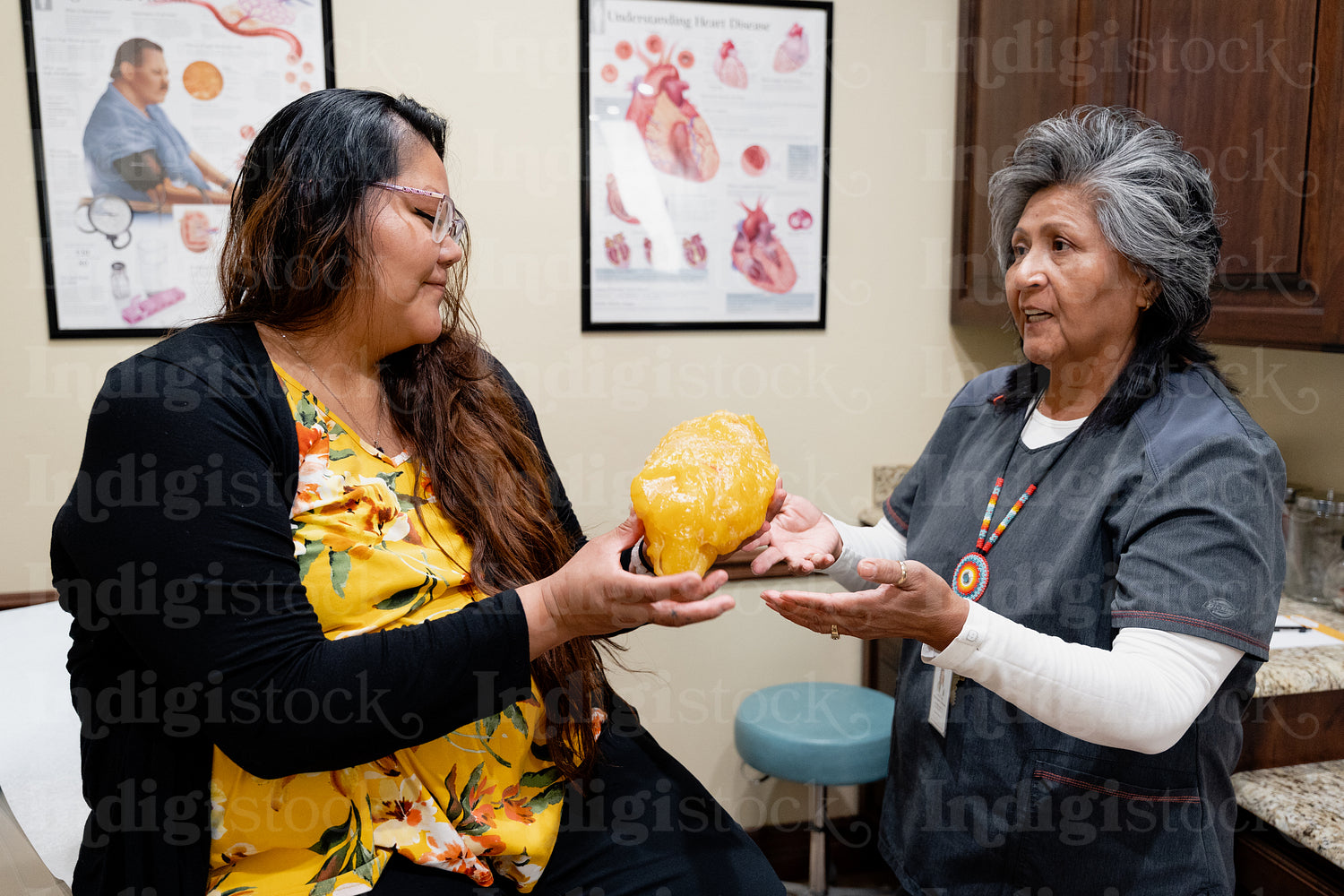 A native woman getting checked by an indigenous nurse 