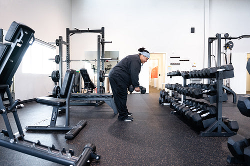 A Indigenous woman working out in a gym