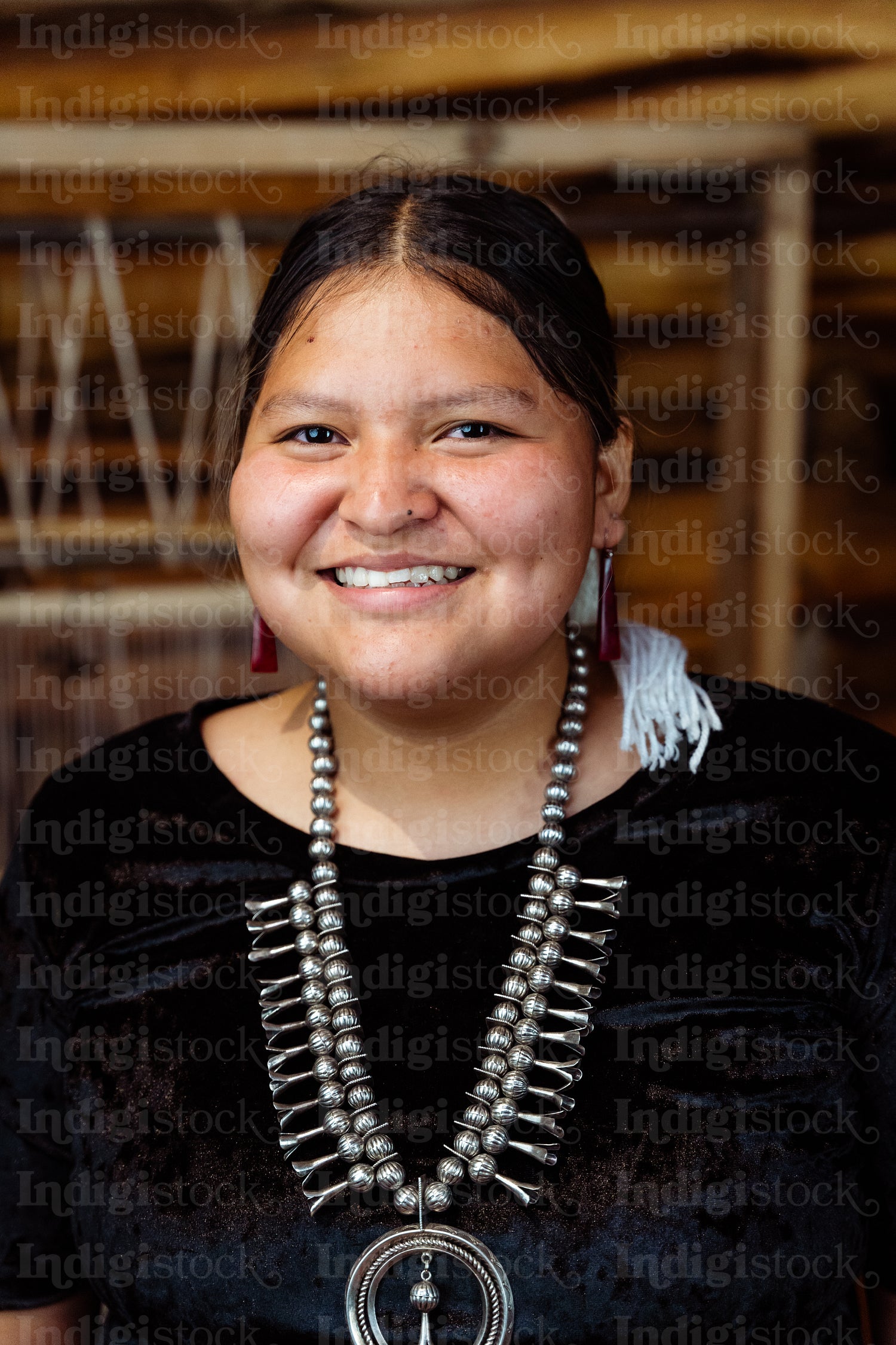 A Native American Navajo woman standing inside a Hogan Earthlodg