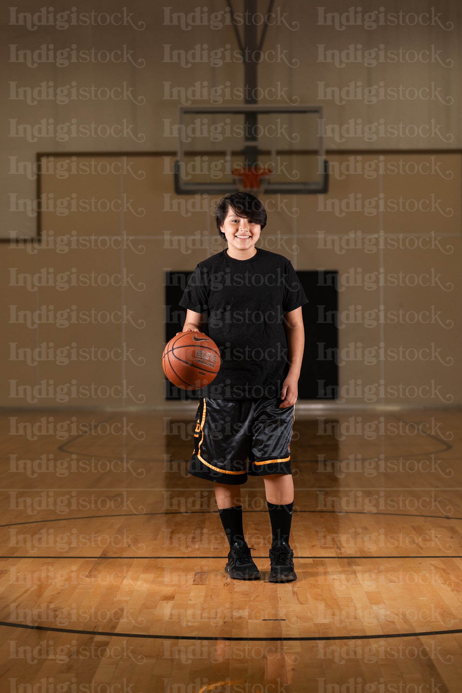 Native youth playing basketball