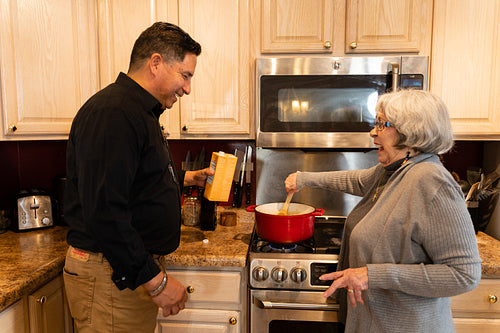 Indigenous mother and son cooking