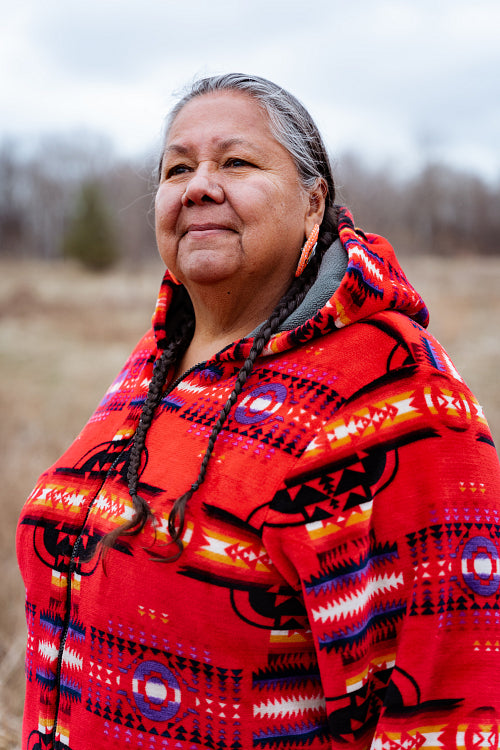 Indigenous elder woman on lake shore