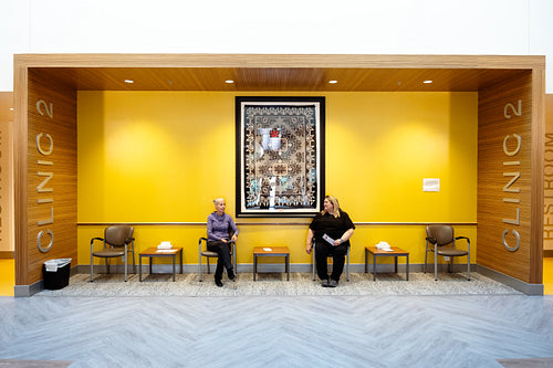 Two women waiting at a health clinic