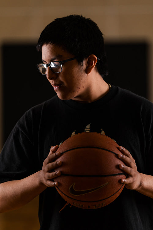 Native youth playing basketball