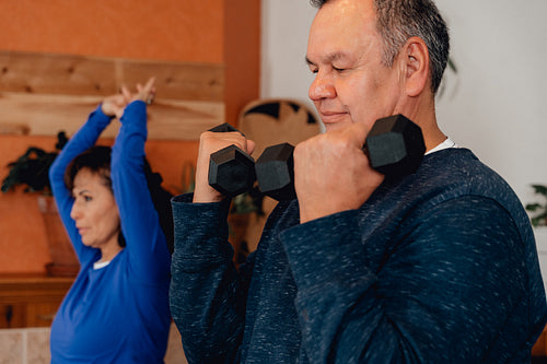 Indigenous couple working out in their home gym