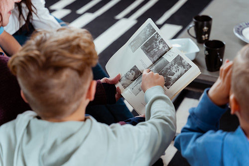 A family of Native Peoples reading a book together