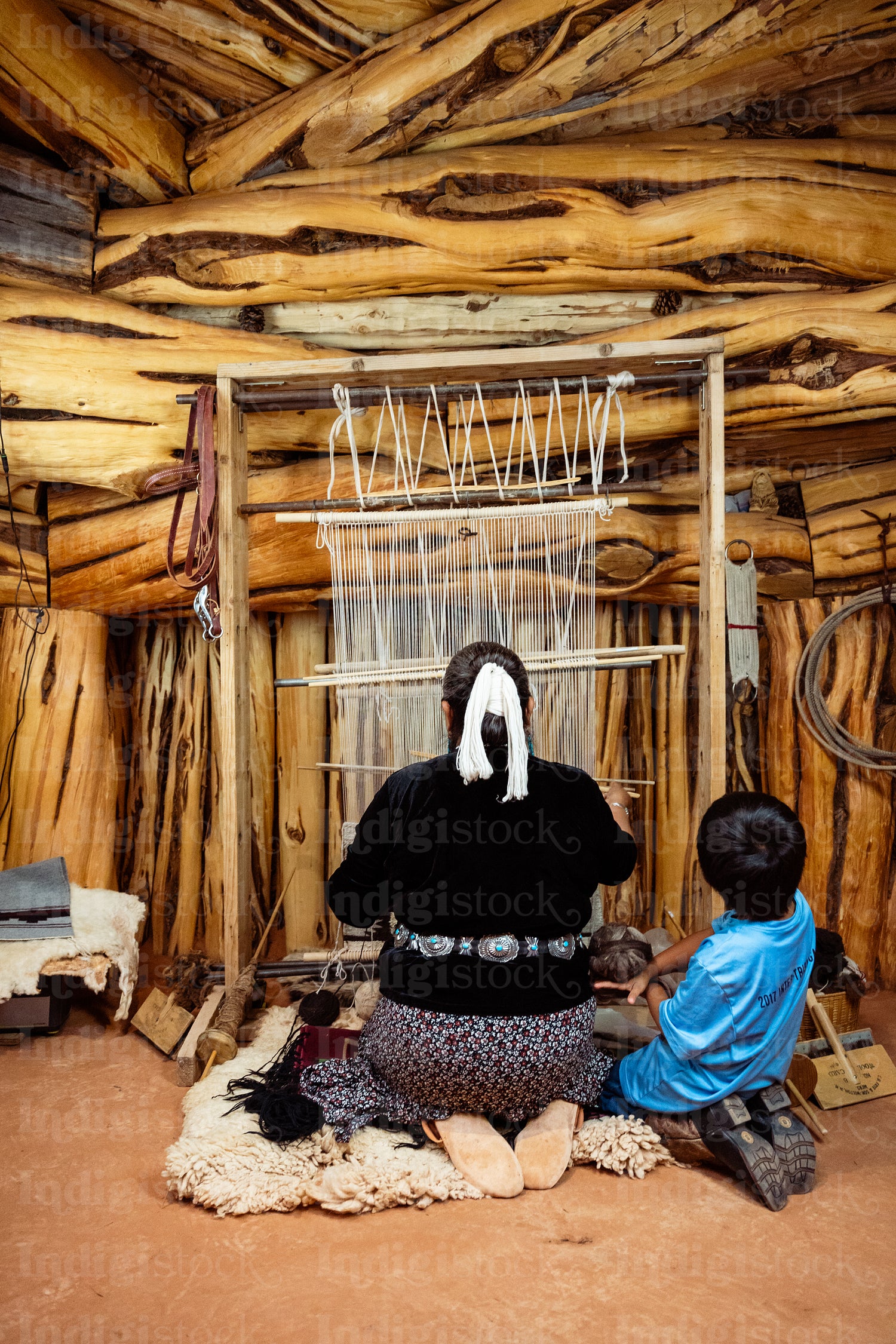 Native Elder showing younger generation the process of tradition