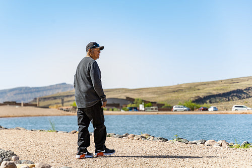 Native Elder enjoying a walk by a lake