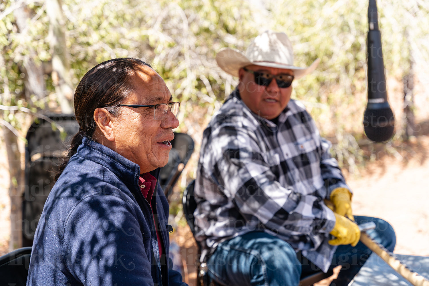 Native men singing songs and playing instruments