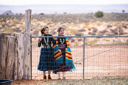 Young native youth wearing traditional regalia outside