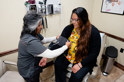 A native woman getting checked by an indigenous nurse