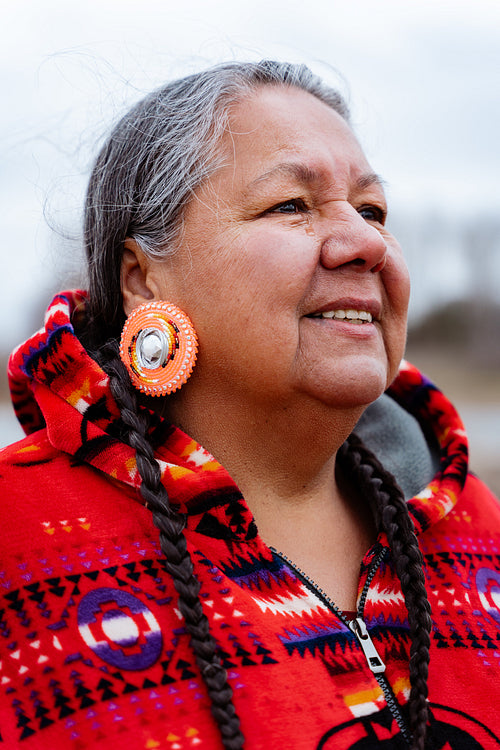 Indigenous elder woman on lake shore