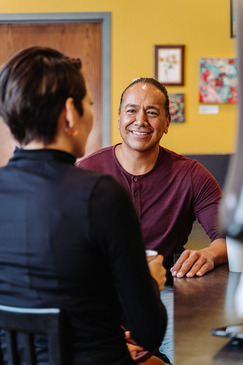 Indigenous couple talking over a cup of coffee