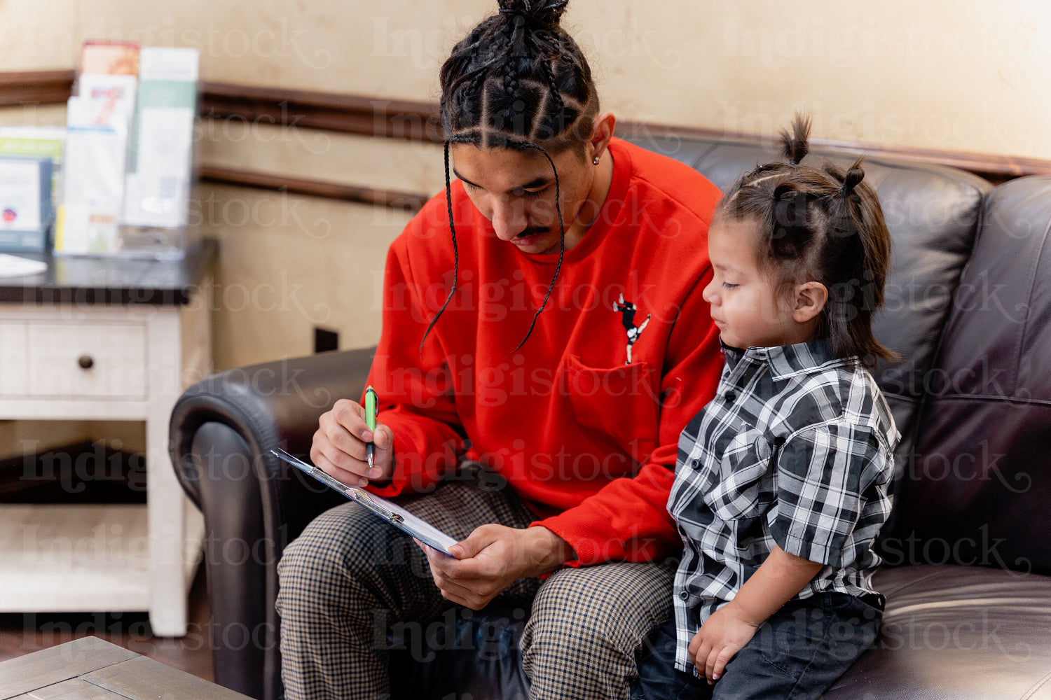 A Native father with his child waiting at a health clinic 