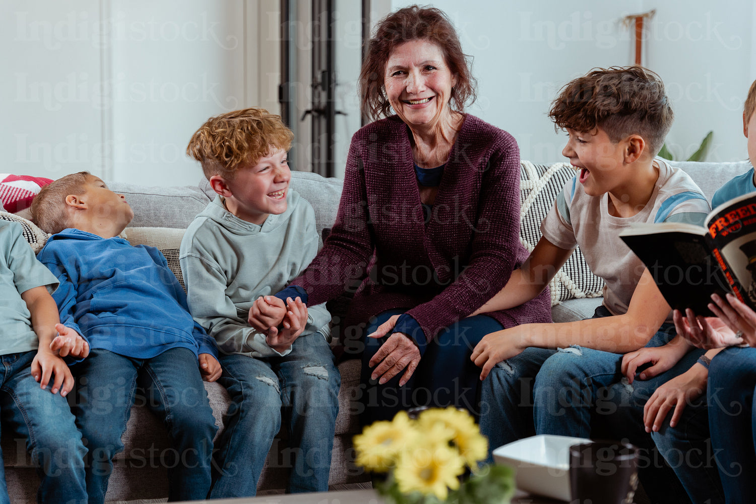 A family of Native Peoples reading a book together