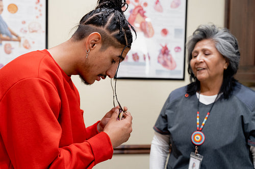 An Indigenous man being check by a native health care nurse