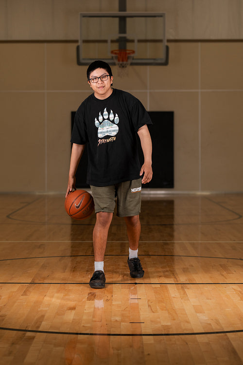 Native youth playing basketball