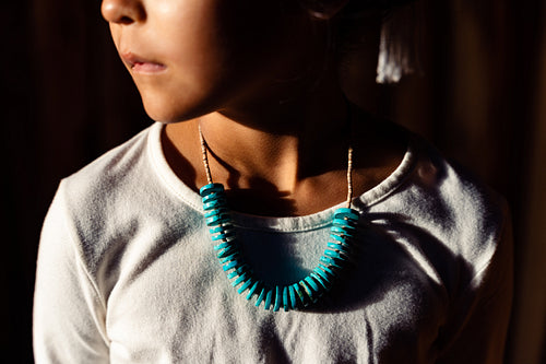 Native American children wearing traditional regalia