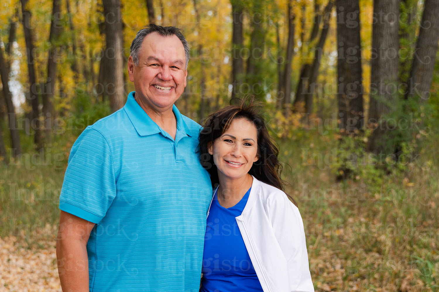 Middle aged Native couple taking a walk through the woods