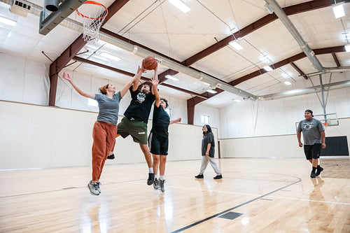 A Native family playing a game of basketball