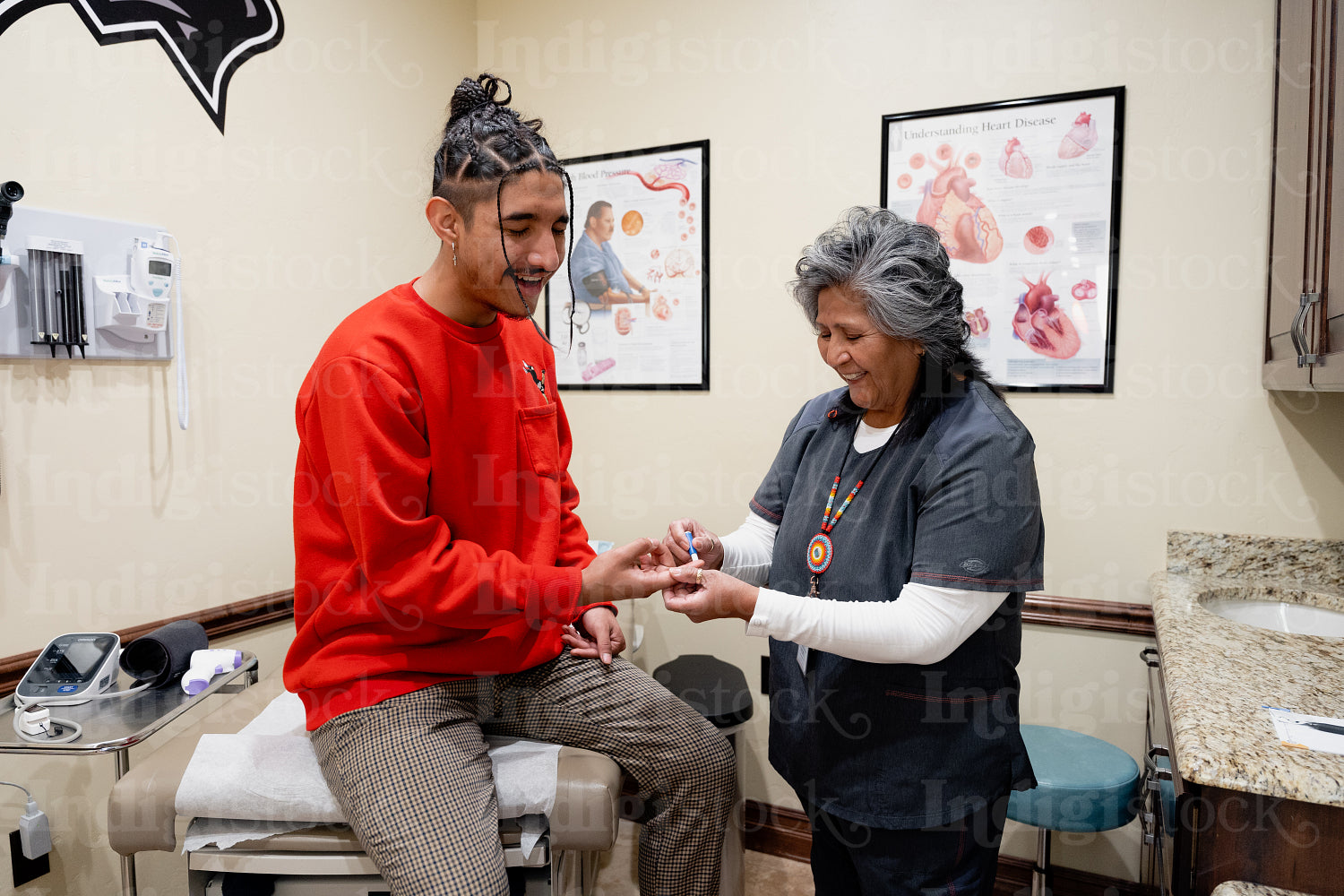 An Indigenous man being check by a native health care nurse