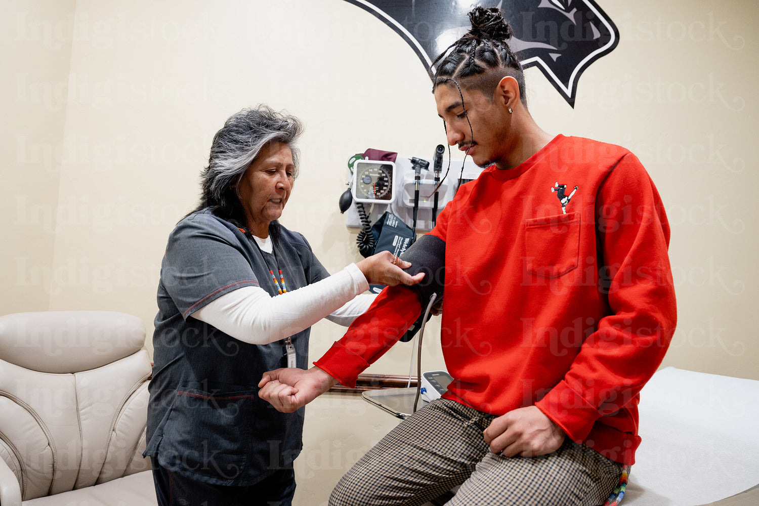 An Indigenous man being check by a native health care nurse